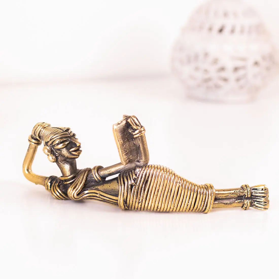 A Leisurely Read Handmade brass figurine in Dhokra art